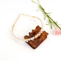 Detail of handmade gold wire-wrapped headband with natural clear crystal stones on a stand - Gold + Double Row White Crystal (Synthetic)