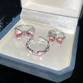 Detailed view of silver bow and heart rings with pink gems on a blue velvet jewelry box - Pink Gemstone Bowknot Heart 3-Piece Set (33# Silver)