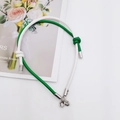 Detail view of green and white leather lanyard with silver geometric metal clasp - White + Green