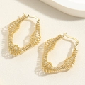 Detail of gold spiral coil earrings with a unique geometric oval spring hoop design - U-Shaped Spiral Ear Buckle Style
