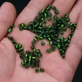 Green transparent glass beads held in hand for DIY jewelry making and craft projects - 4mm / 15g / Green
