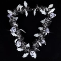 Halloween wreath with LED glowing skull heads and white ghosts on black fringe - 7 LED Skull Necklace with Tinsel