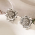 Eleganti orecchini a lobo a fiore in argento lucido posati su un vassoio di ceramica - Fiore d'Argento