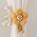 Close-up of yellow flower curtain tieback with white embroidery and beige fabric bow - Ginger Yellow (Cotton Five-Petal Flower)