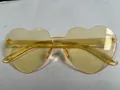 Frameless heart-shaped sunglasses in candy yellow color with integrated nose bridge - Light Orange