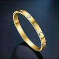 Gold stainless steel bangle featuring clover motifs and sparkling zircon inlays - Gold Color Clover Bangle (35-D-8) / Gold