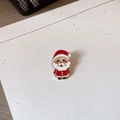 Detail of Santa Claus enamel brooch with vibrant red and white glaze and gold metal edges - Santa Claus / 0.1