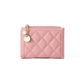 Detail of pink quilted wallet featuring a gold zipper and decorative pearl charm - Pink