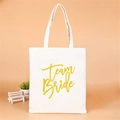 White canvas tote bag with gold Team Bride lettering for bridesmaid parties - Style A (Team Bride/Gold Art)