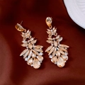 Dettaglio di orecchini a nappa con cristalli champagne su elegante seta marrone scuro - Stile Pendente a Goccia d'Acqua Oro Champagne