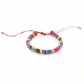 Detailed view of handmade bohemian woven surfing bracelet with colorful stripes on white background - No. 23