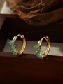 Close-up of 18K gold plated flower hoop earrings with turquoise stones on wooden stand - ZHE1534 Style - Blue Rhinestone / 18K Gold