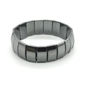 Macro shot of dark grey metallic magnetic hematite bracelet on a white background - Large Half Moon