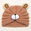 Close-up of winter baby knitted bear hat showing thick warm yarn texture and fuzzy ears - Nude Pink