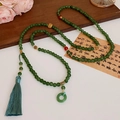 Green stone bead necklace with gold Fu character bead and blue silk tassel detail - Green Bead Tassel Style