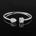 Macro shot of S925 silver open bangle with pear and emerald cut crystals and mirror reflection - Pear & Rectangle Double Head (s5214-silver) / Silver Asymmetric Style