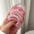 Close-up of assorted pink and transparent spiral hair ties held by hand - 18# Pink (Set of 6)