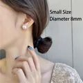 Classic 8mm white pearl stud earring in S925 silver worn on model's ear - Small Pearl Stud Earrings 1 Pair