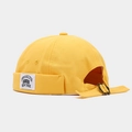 Detail view of the yellow canvas docker hat with retro metal adjustment buckle and side label - Adjustable / NEW YORK Patch Yellow