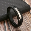 Detail of black braided leather bracelet with silver metal plate on a wooden surface - Black & Matte Clasp & Silver Steel Pipe