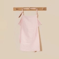 Close-up of pink cotton waffle nursing cover with soft texture on a wooden hook - Pink with Metal Buckle