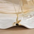 Gold hummingbird pendant necklace with black gemstones and white crystals on white tray - FN0106 Oval Black Gemstone Hummingbird