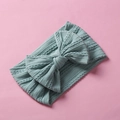 Detail showing knit cable texture and large bow on a soft green nylon infant headband - Blue Gray