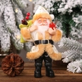 Statuetta di Babbo Natale in resina con tunica bianca e sacco verde su sfondo boschivo - Babbo Natale in Resina Beige