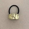 Minimalist black elastic hair tie with irregular gold wavy metal ornament for women - Oval Embossed Metal Pattern Gold