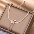 Close-up of rose gold butterfly necklace with frosted texture and beaded snake chain - Rose Gold (BXG016-3)