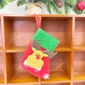 Red felt Christmas stocking with reindeer applique and green sequin cuff hanging on wood - Sequin Small Stocking (Reindeer Style)