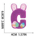 Detailed embroidery patch of purple letter C with rabbit ears and Easter egg motif - Letter C
