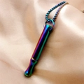 Macro detail of rainbow meditation breathing whistle necklace on beige silk background - Cylindrical Tube Necklace / 50+5cm Chain Length / Colorful