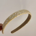 Macro shot of gold sequined headband with shimmering glitter details and smooth lining - Yellow