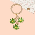 Cute daisy keychain with three green and yellow flowers on gold metal link chains - Green