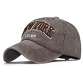 Detailed close-up of brown 3D embroidered NEW YORK EST. 1625 text on washed cotton cap - NEW YORK Coffee