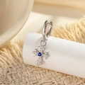 Silver cross earrings with zircon pavé and blue gemstone on a display stand - Royal Blue (A880-5# Single Piece)