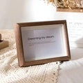Minimalist natural wood picture frame with white mat on a decorative lace tablecloth - Walnut