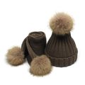 Detailed close-up of brown knit texture and fluffy faux fur pom-poms on winter hat set - Light Coffee