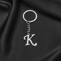 Polished stainless steel letter K keychain in silver finish on black silk background - Letter K