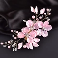 Close-up of pink petals and pearls woven with wire on dark silk bridal hair clip - Gold Wire Pink Flower