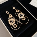 Close-up of golden multi-hoop earrings with hammered texture in black jewelry box - Gold / Gold