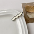 Detail view of wavy black and ivory hair clip on ceramic plate with elegant aesthetic - 6# White Curved with Black Edge