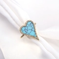 Gold heart turquoise ring with pave zircon borders on white satin fabric background - Turquoise Blue