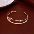 Double-layered rose gold open bangle featuring heart-shaped zircon and pave crystals - Gold Heart Gourd Style (HB4380)