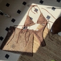 Detailed texture of coffee crochet bikini set with mesh skirt on a textured background - Coffee