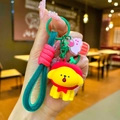 Cartoon dog keychain with red hooded cape, woven strap, and cupcake charm held in hand - Red Apple Headgear Dog