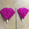 Macro shot of two rose pink metallic cheerleading pompoms with a measuring tape guide - 80 Pieces/Pack Straight Handle / Rose Red