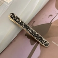 Sparkling dark rhinestone hair clip with gold metal base on a fashion magazine - Bright Black (Bead Chain Style)