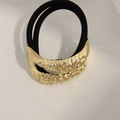 Minimalist black elastic hair tie featuring a metallic gold hammered textured bead charm - Double Rope Curved Pattern Gold